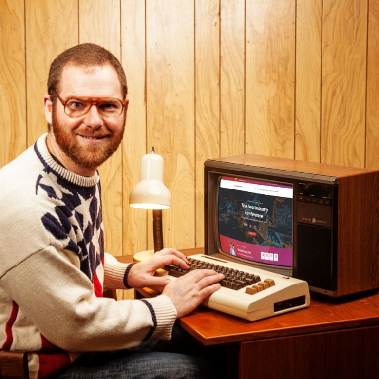 An image of Jeff at his vintage computer, smiling.
